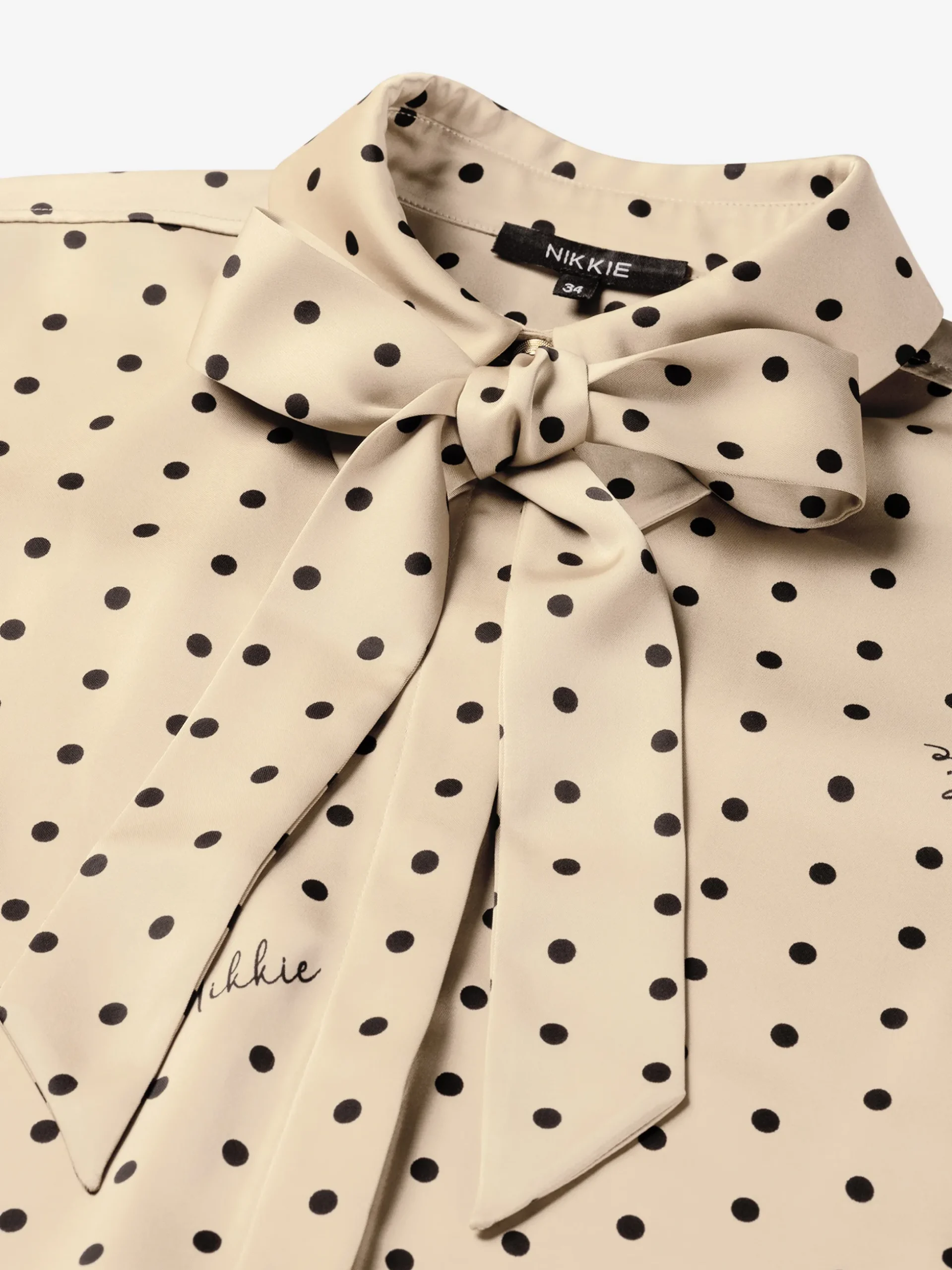 Blouse met stippen en strikkoord