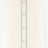 Korte tweed rok met N-knopen en glimmende biezen