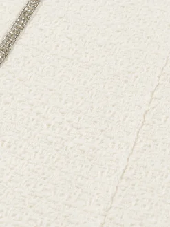 Korte tweed rok met N-knopen en glimmende biezen