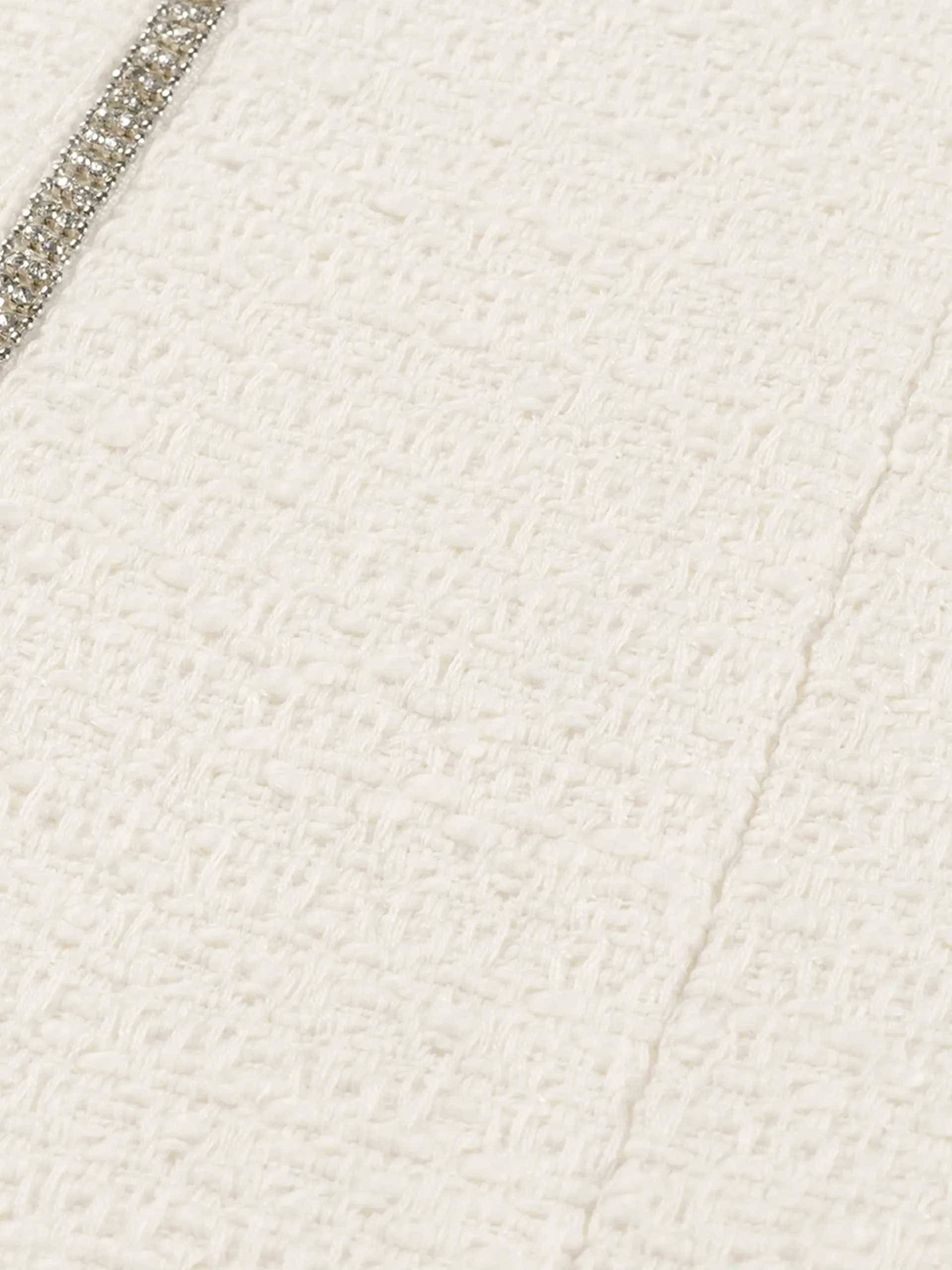 Korte tweed rok met N-knopen en glimmende biezen