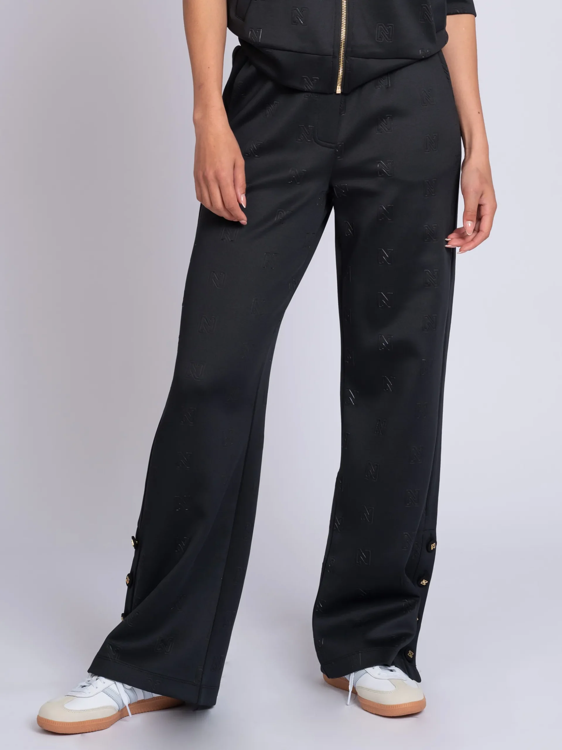Losvallende broek met logo patroon en sierknopen