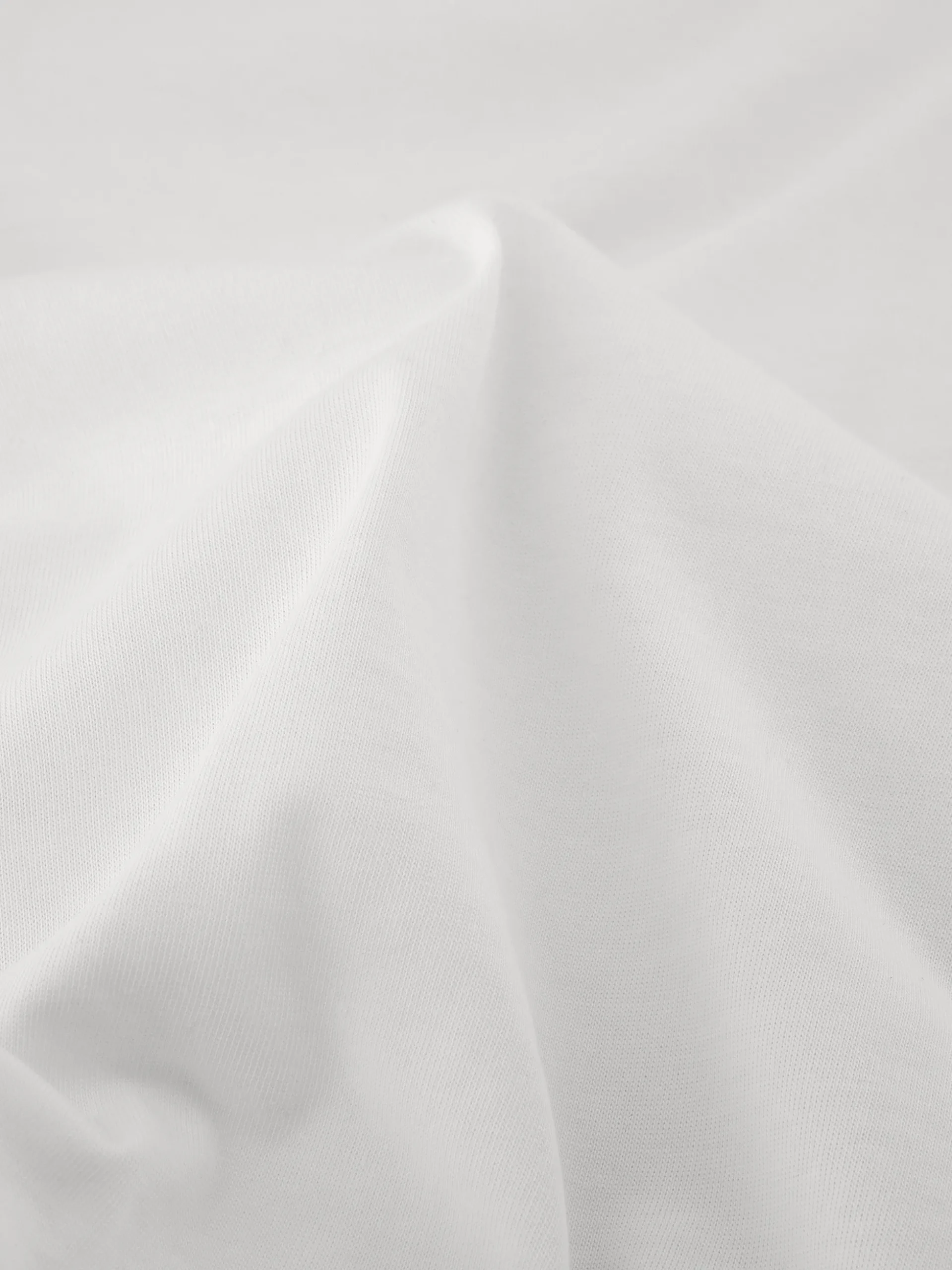 Top met draperende halslijn en rits detail op schouder